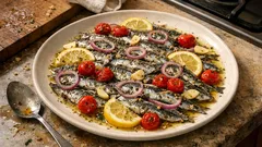 Γαύρος στο φούρνο λαδορίγανη: ζουμερός σε 15′ με λεμόνι, σκόρδο και ντοματίνια